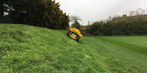 Spider ILD01 cutting grass on slope next to sports pitch